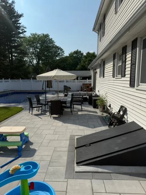 Paver patio installation creating an outdoor living space at a home in the Greater Boston area.