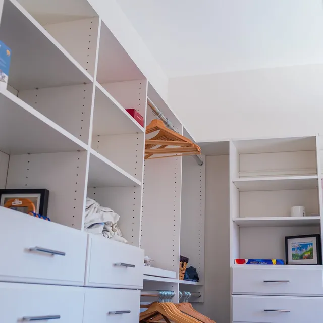 Custom walk-in closet with adjustable shelving and drawers