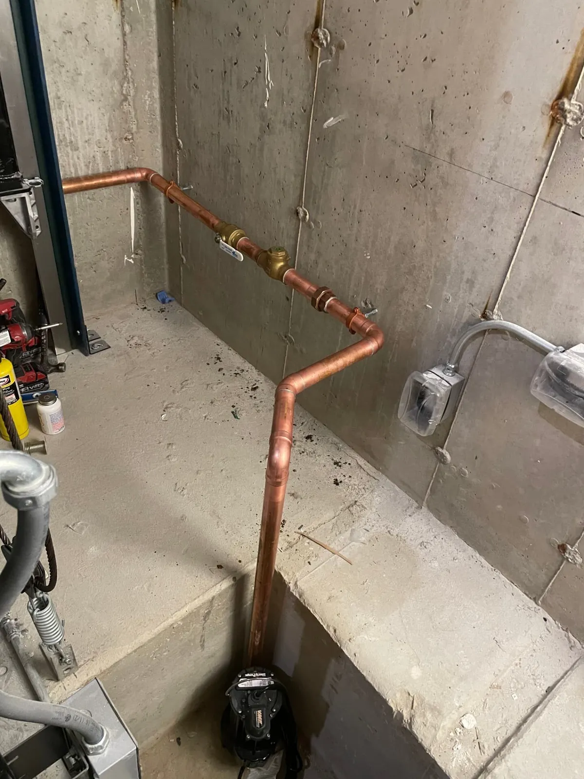 Elevator sump pump installation with copper discharge piping in North Andover, MA by Top Shelf Plumbing & Heating