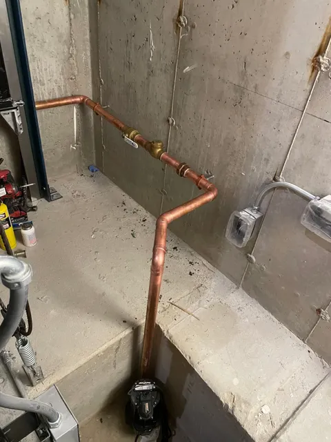 Elevator sump pump installation with copper discharge piping in North Andover, MA by Top Shelf Plumbing & Heating