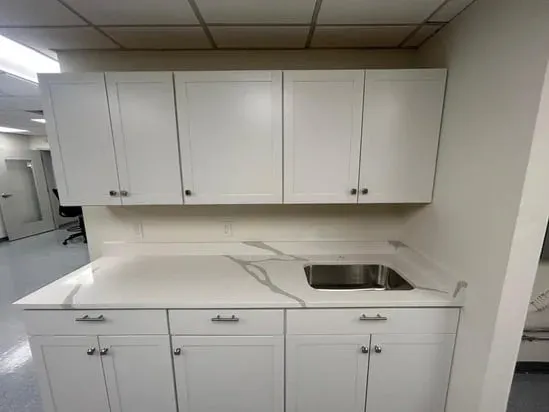 Close-up of a stainless steel sink installed into a Calacatta Cosmos Roxbury MA quartz surface.