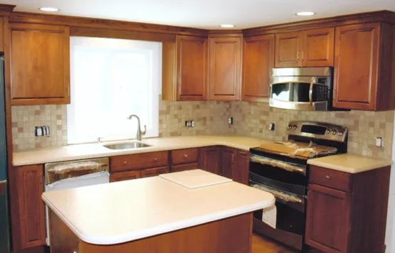 Completed kitchen with island, tile backsplash and stainless appliances