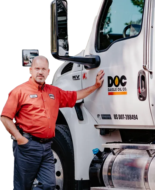 daigle working in his work uniform leaning against a fuel delivery truck
