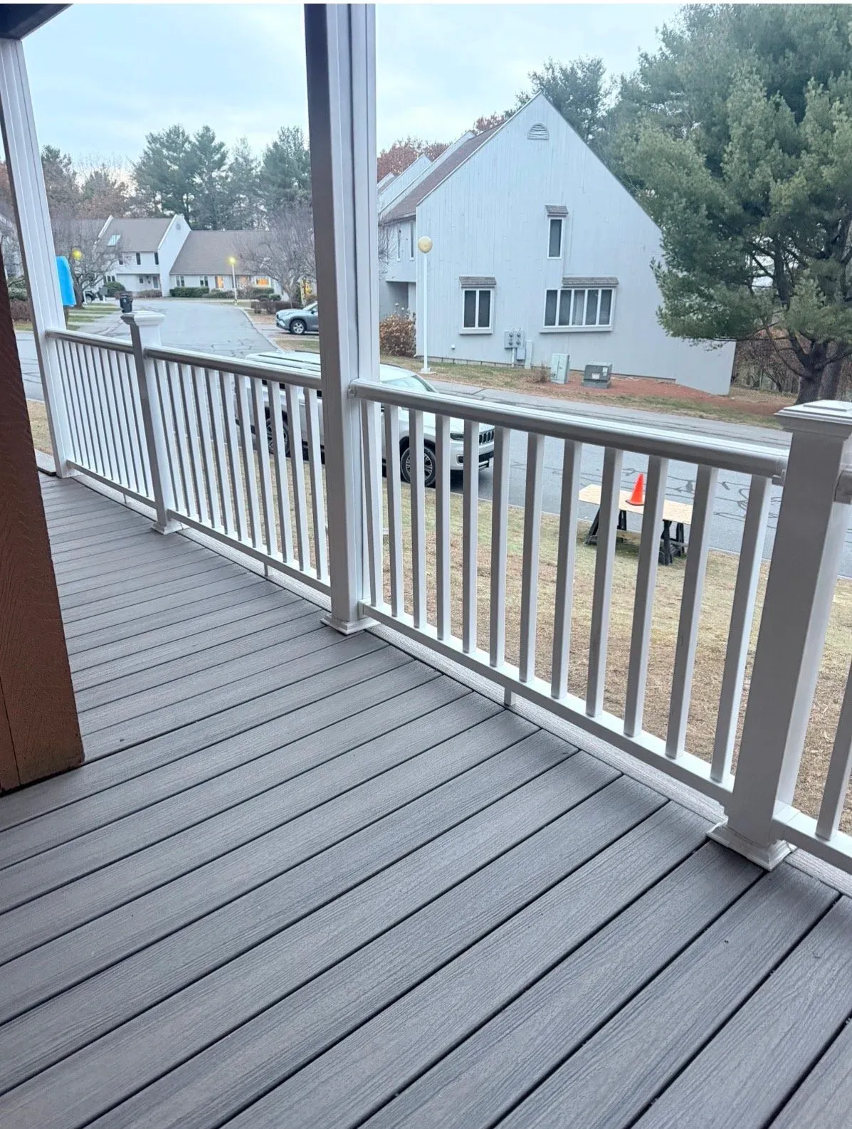 View of new Trex Enhance composite decking and vinyl hand rails installed by A+ Exteriors.