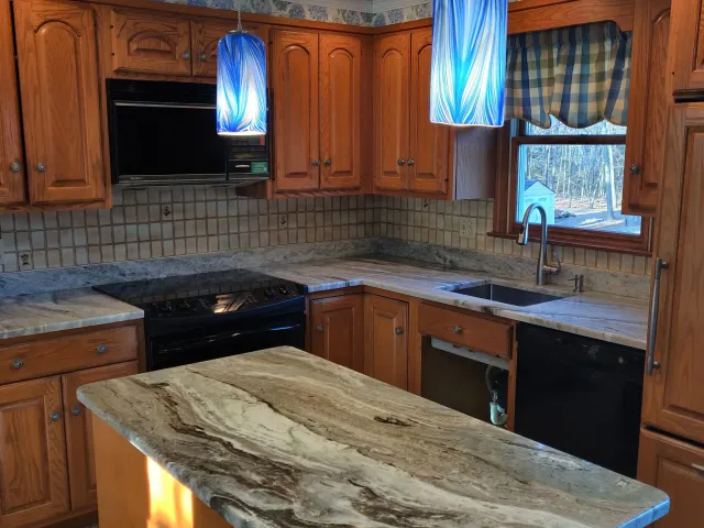 Modern white kitchen with quartz countertops and large island