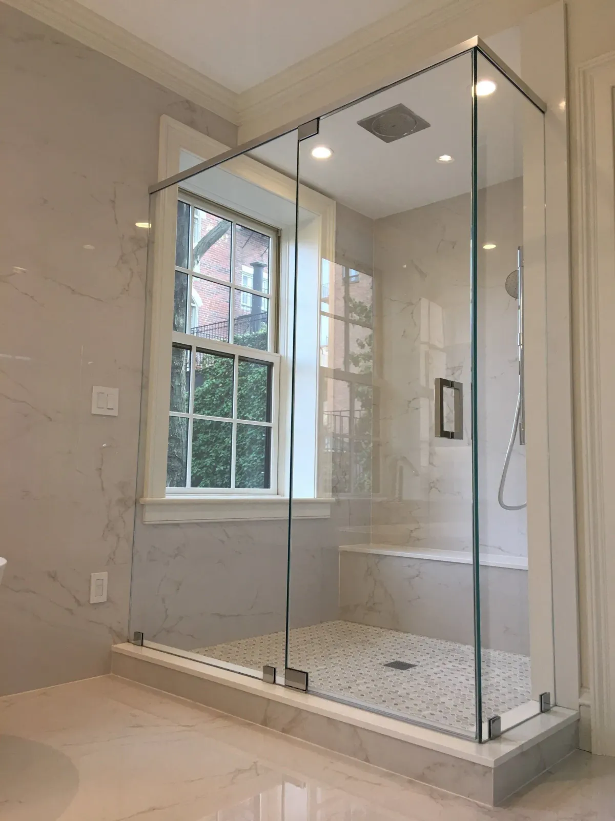 a bathroom with a walk in shower and a window