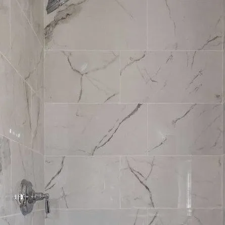 Large format marble effect tile in a finished shower