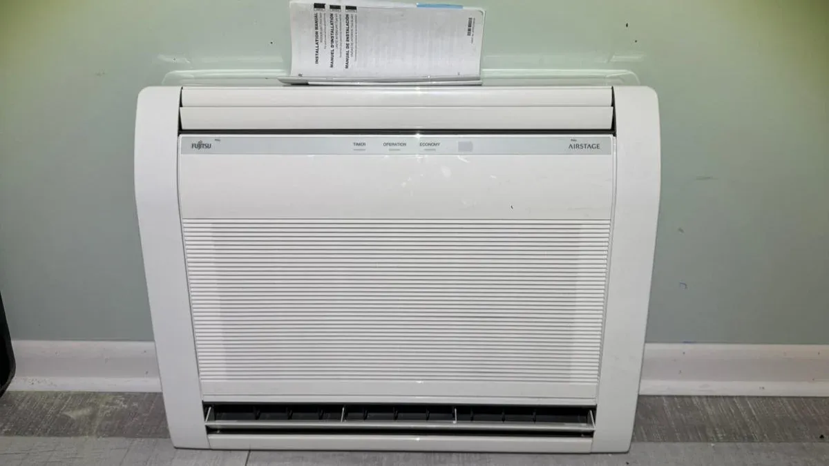 Newly installed Fujitsu Airstage floor-mounted ductless heat pump unit