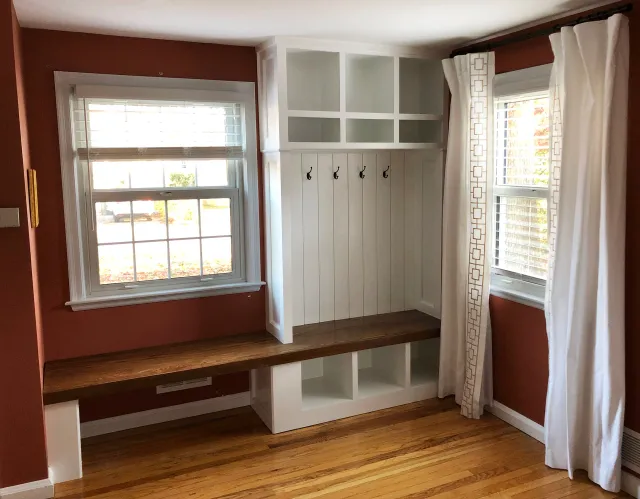 Built-in storage for coats, shoes, and backpacks tucked next to the front entry of the client's home