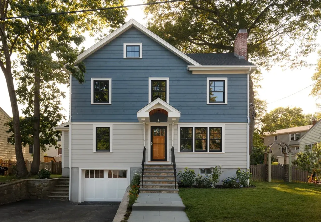 Newly rebuilt front entrance with blue stone stairs, the house has new siding