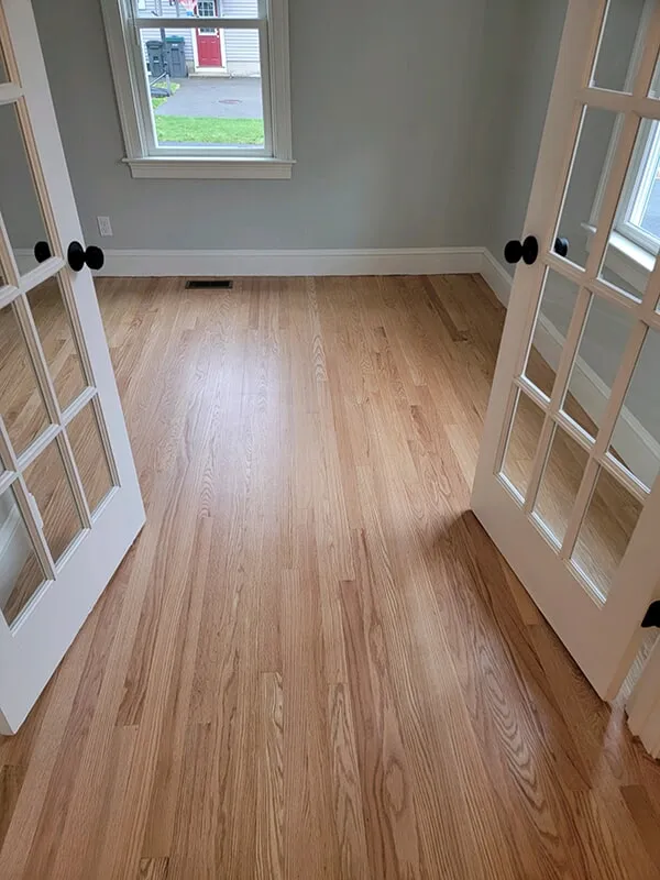 Double doors opening to hardwood floor office in Ashland, MA