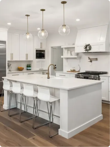Kitchen remodel in Lexington, MA with white Shaker cabinets, quartz waterfall island and stainless appliances