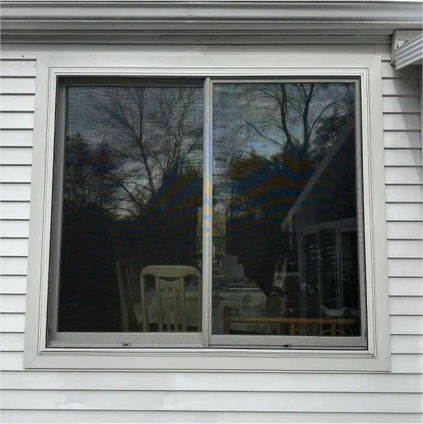 A renovated window on a white, vinyl house