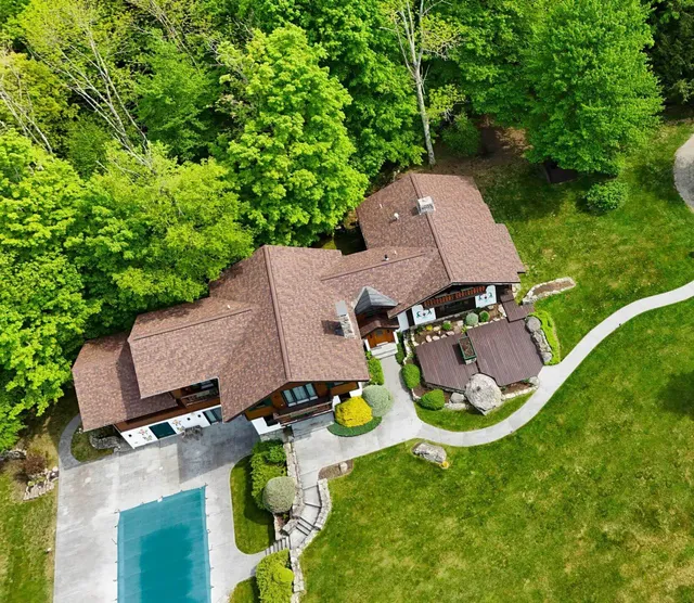 Asphalt shingles roofing material on large home vs other roofing types.