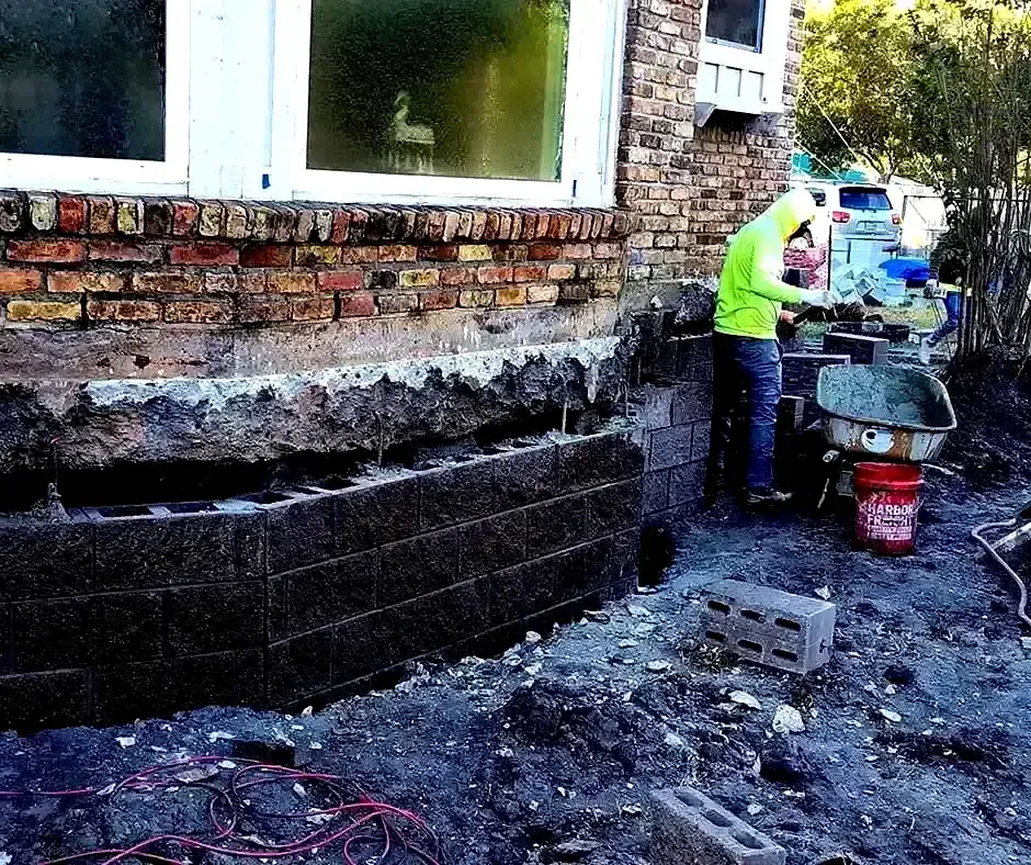 Worker rebuilding Foundation Repair Boston, MA