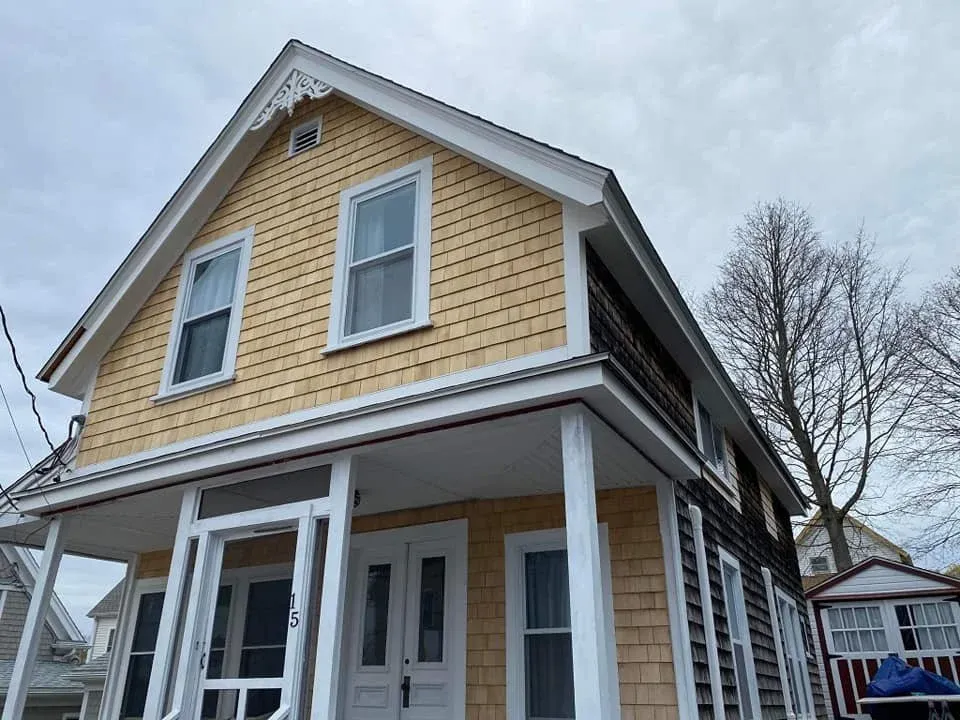 After of before picture, showing the siding/shingling of the house clean, looking brand new.