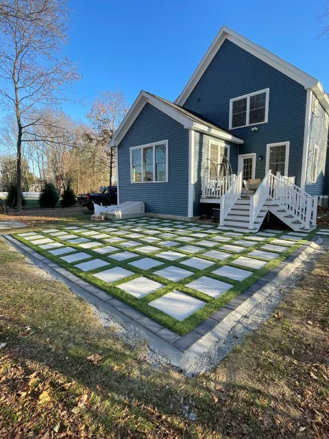 Modern patio built in Exeter, NH with techo-block pavers and golden vale turf, hardscaping by The Englishmen Masonry