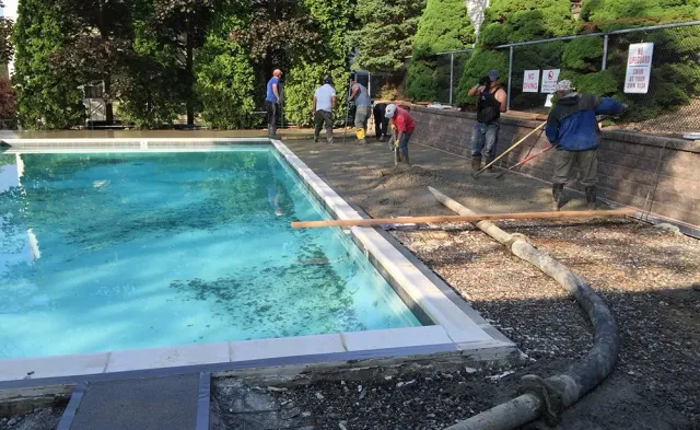 A group of people are working on a swimming pool.