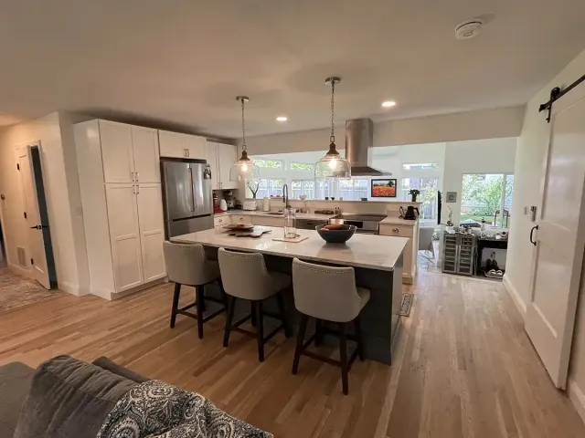 Kitchen remodel with quartz island and vented range hood