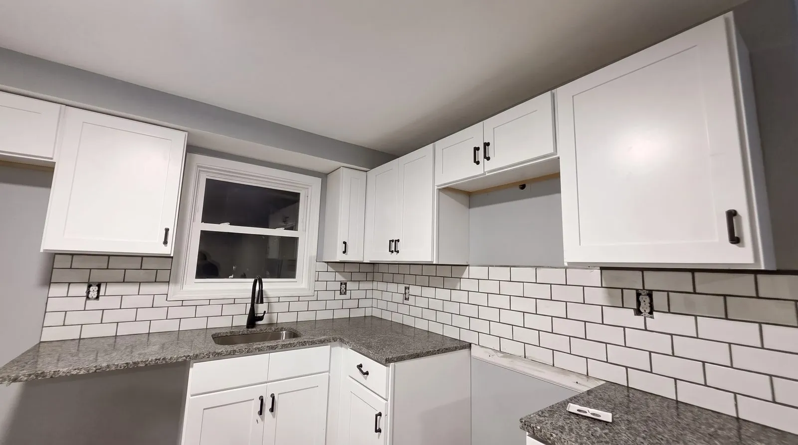 Kitchen finished — white shaker, subway tile