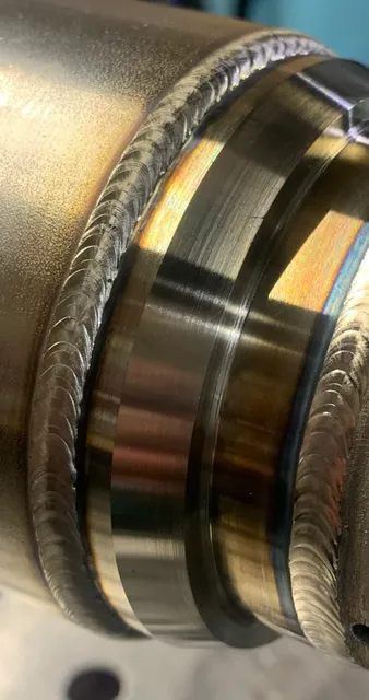 Close-up of welds on a multistage stainless pipe assembly