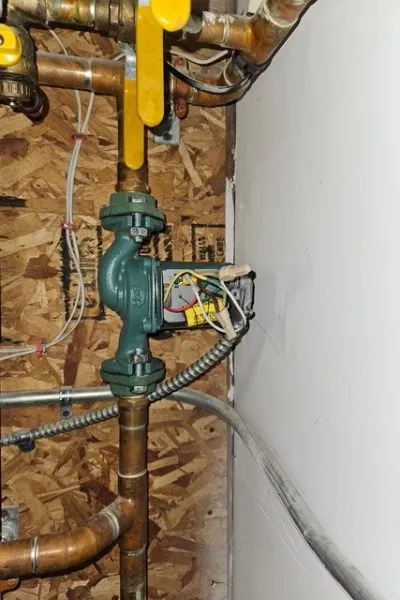Green circulator pump with copper piping