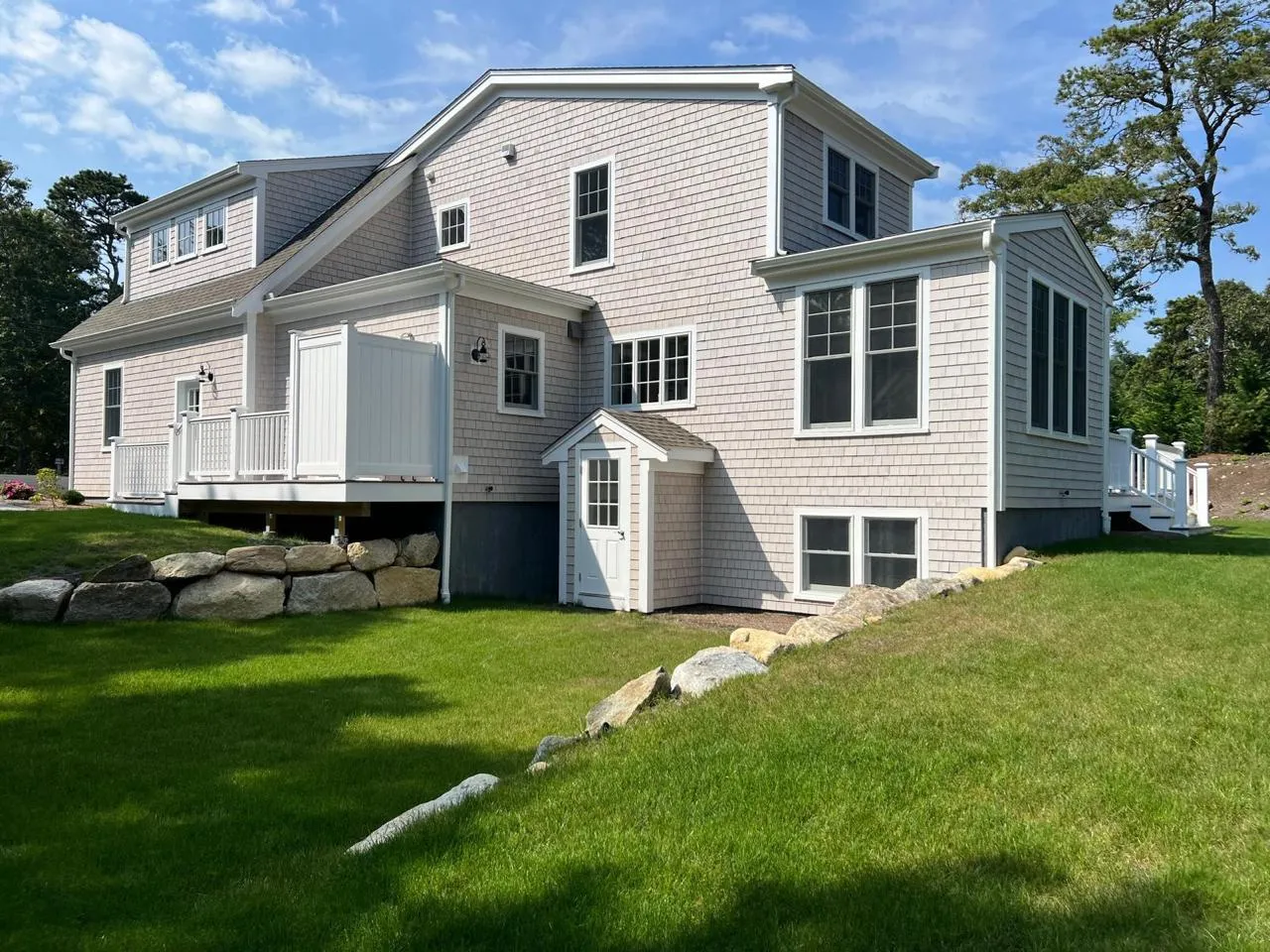 Exterior of a Cape Cod style home painted by HMS Painting