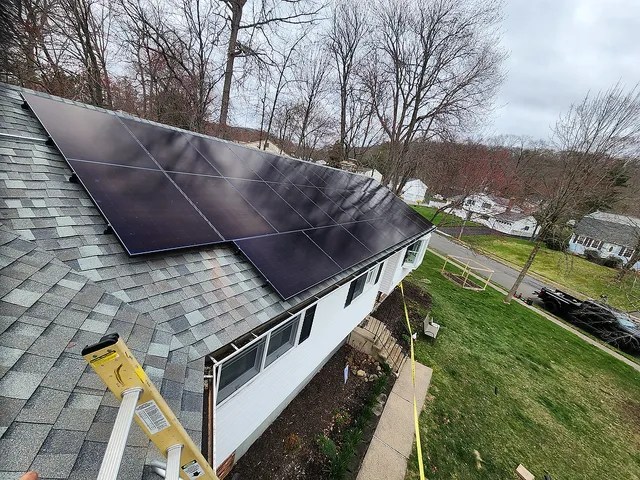 Rooftop solar panel array close-up from ladder