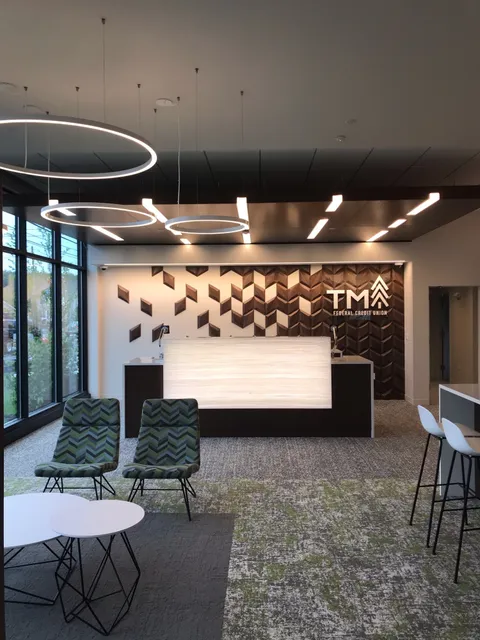 Interior of building with front desk and sitting area and trademark Federal Credit Union Logo