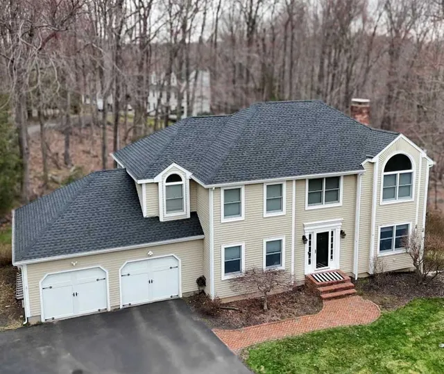 Gray two-story home with an attached garage and gray roof