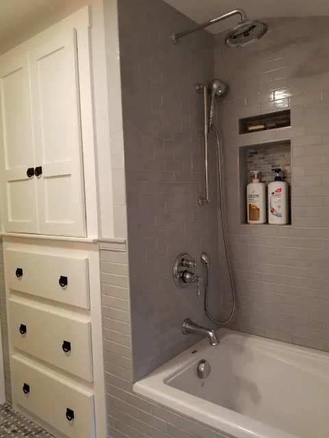 A bathroom with a bathtub and a shower.