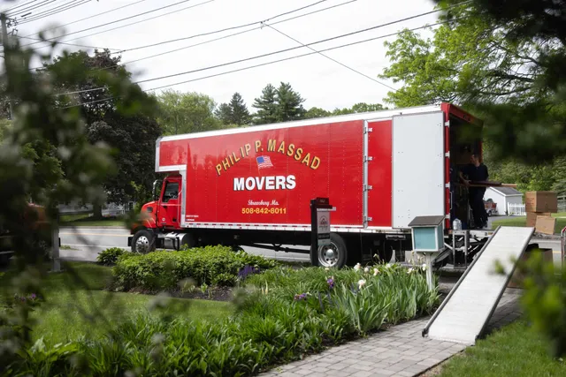 A moving truck is parked in front of a house.