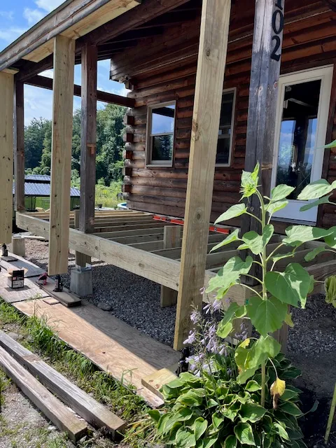 Deck framing rebuild in progress at a Goffstown log home