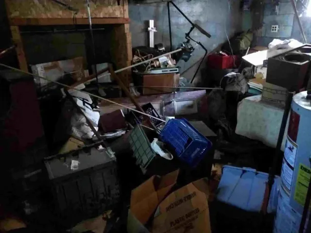 Before junk removal — basement cleanout in Providence, RI rubbish filled basement with piles of old junk