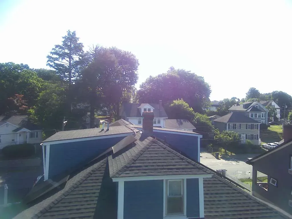Top Tier Construction crew installing a new roof in Massachusetts