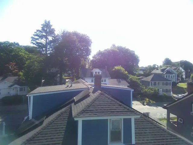 Top Tier Construction crew installing a new roof in Massachusetts