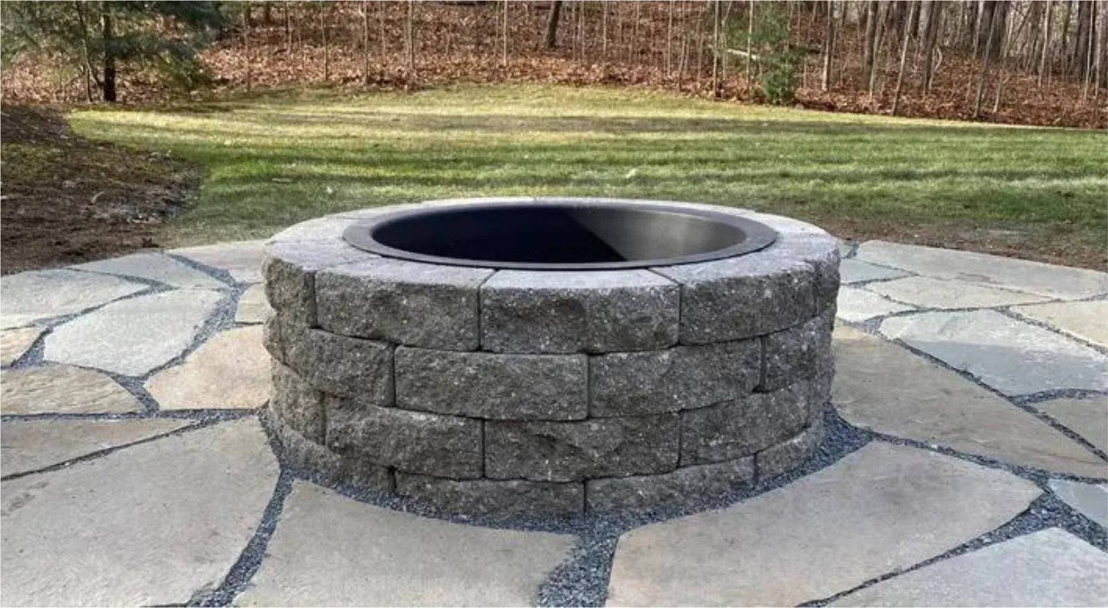 Stone fire pit set in flagstone patio