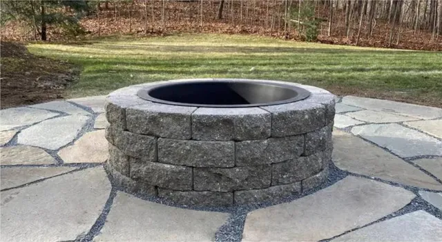 Stone fire pit set in flagstone patio