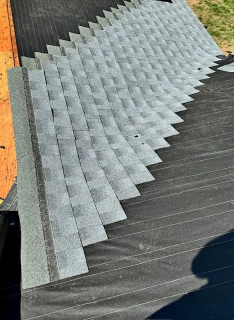 Close view of reshingle work during an Amherst roof repair