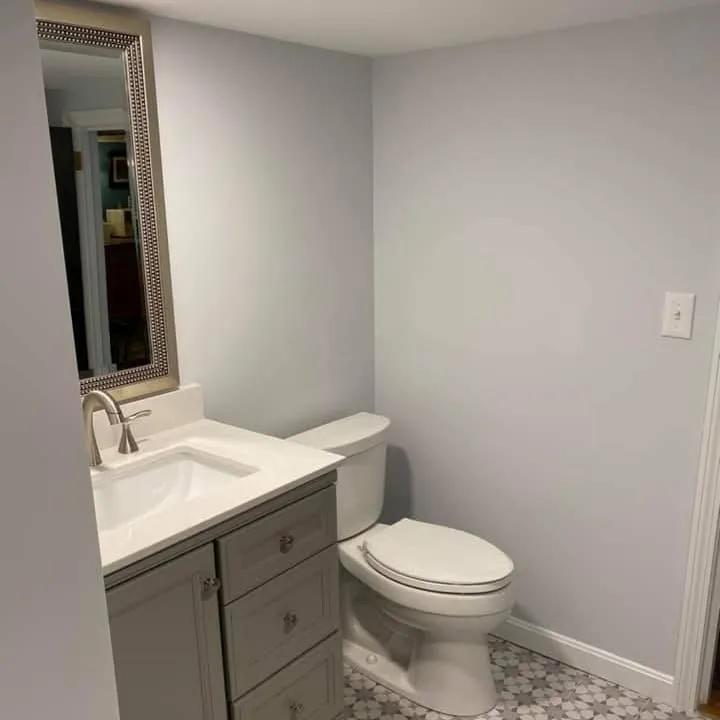 Completed half-bath with new vanity and patterned tile floor
