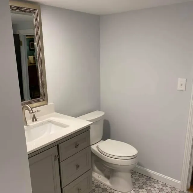 Completed half-bath with new vanity and patterned tile floor