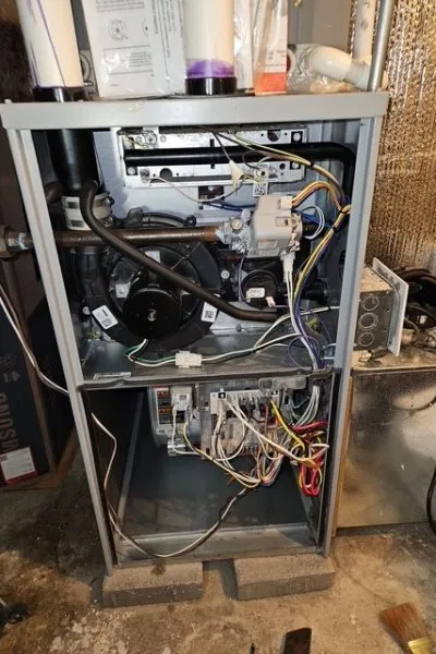 Open furnace with exposed wiring and components
