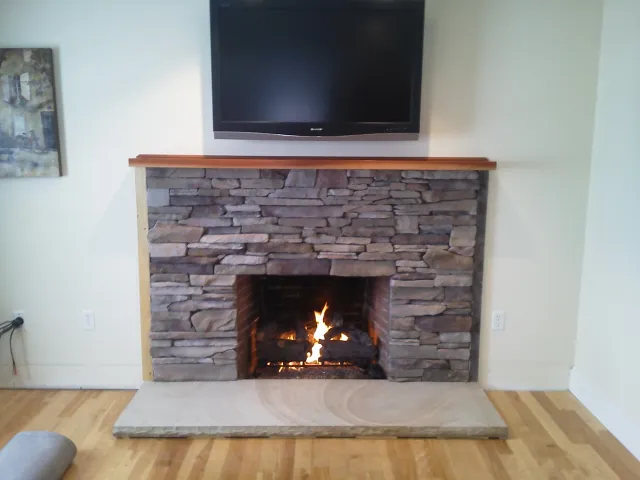 Custom ledge stone veneer with New Hampshire granite hearth - NH Chimney Sweep