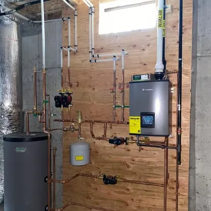 High-efficiency boiler installation with expansion tank and copper piping manifold by Top Tier Plumbing & Heating LLC