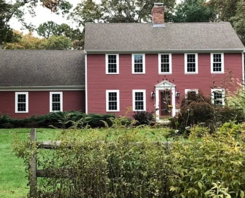 maroon house with new windows and siding