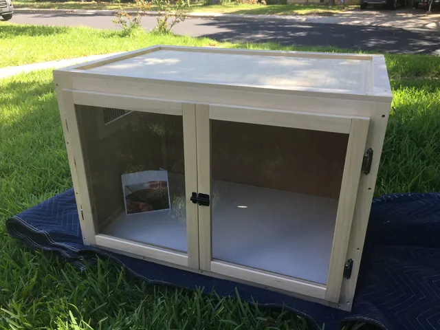 wood, melamine, and plexiglass lizard enclosure with latching doors