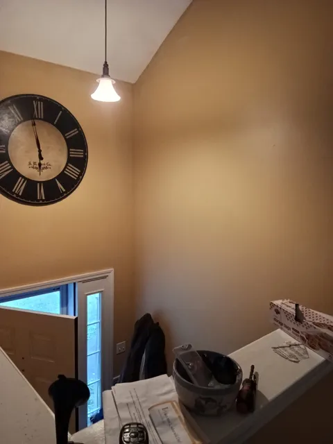 Yellow living-room walls and stairwell before painting.
