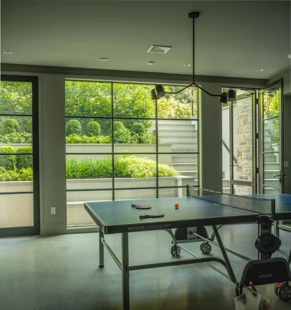 Designed for days spent inside&mdash;without losing the connection to outdoors.
Stepped walls invite light into the lower level rec room and reveal layered planting beyond, creating a quiet dialogue between interior comfort and the garden outside.

P