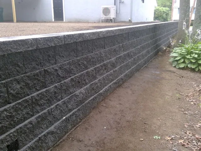 GravityStone® Fat Face interlocking retaining wall blocks installed in Reading, MA, highlighting durability and modern design.