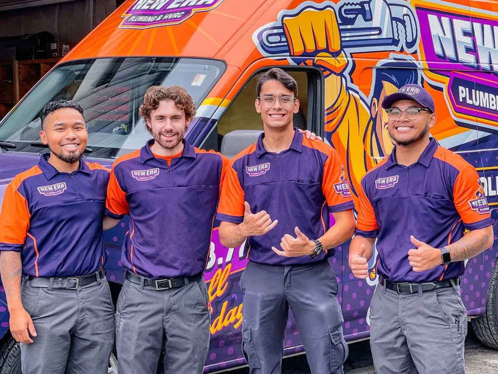 Four New Era team members pose in front of a service van